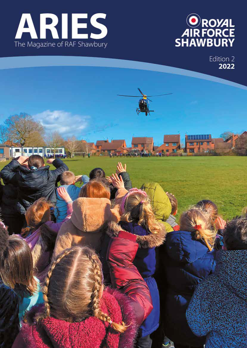 Image shows school children waving to helicopter as i flies overhead.